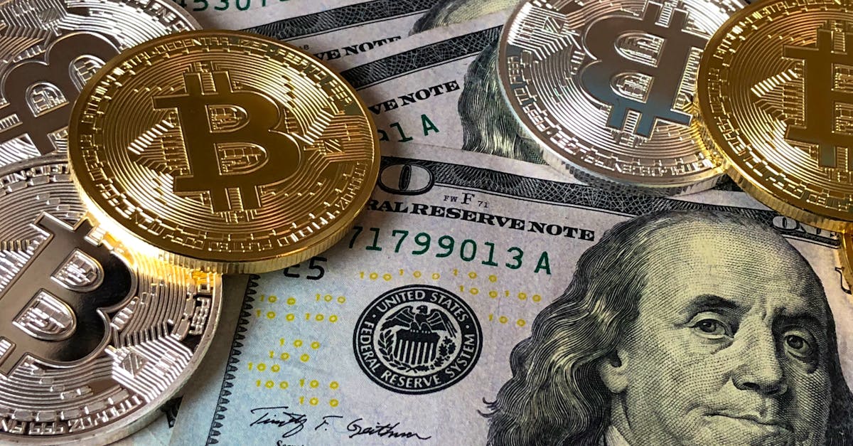 A close-up photo depicting Bitcoin coins on top of US dollar bills, symbolizing finance and cryptocurrency.