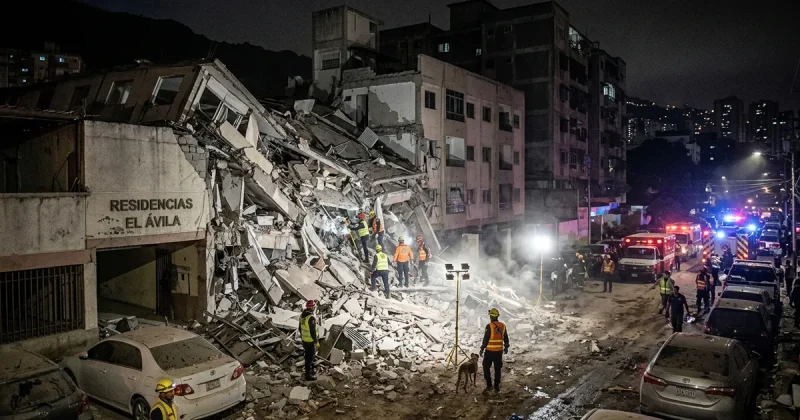 Rescue workers with floodlights search a collapsed apartment building at night after twin earthquakes in Venezuela