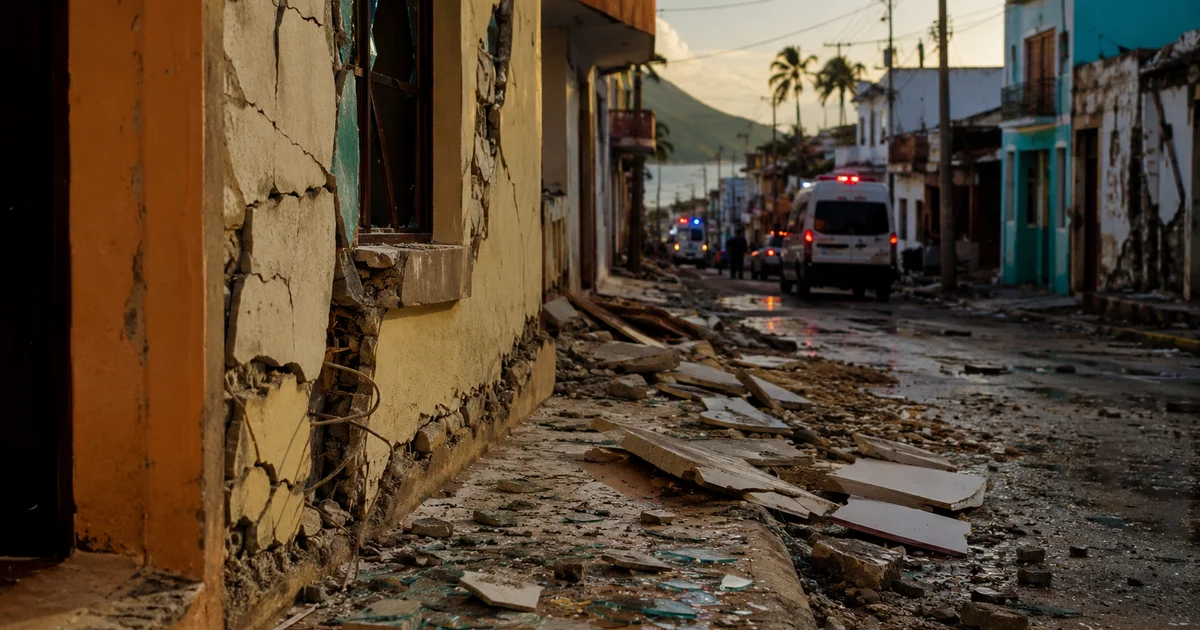 Earthquake damage in a Mexican coastal town with cracked walls and emergency response vehicles