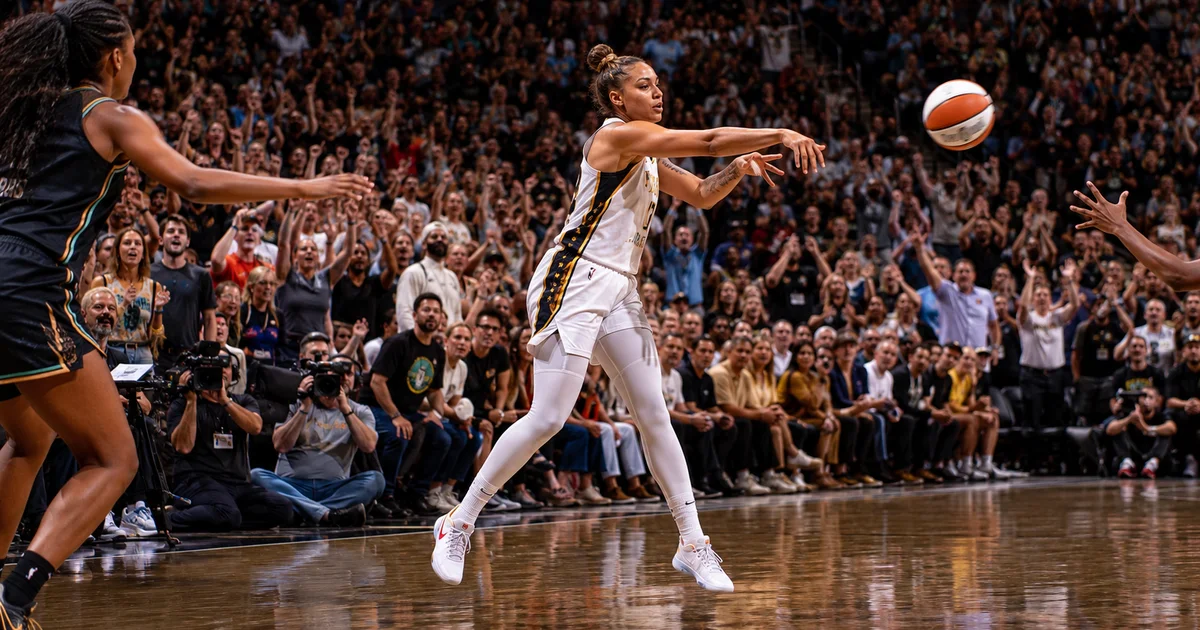 Dynamic action shot of women's basketball game in packed arena with television cameras courtside