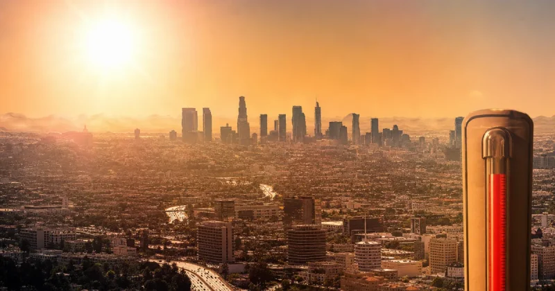 City skyline shimmering under extreme heat haze with blazing sun overhead