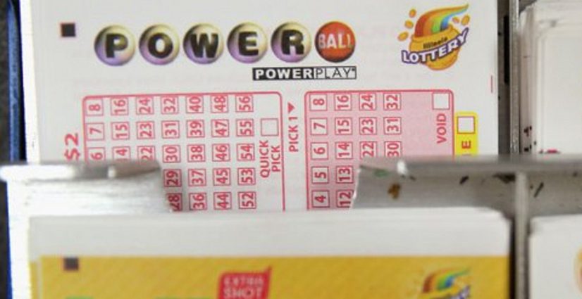 Powerball with Power Play play slips in a rack at a US lottery retailer