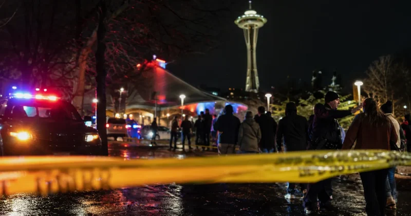 Police emergency lights and yellow tape at Seattle Center near the Space Needle after a mass shooting at the Bite of Seattle festival