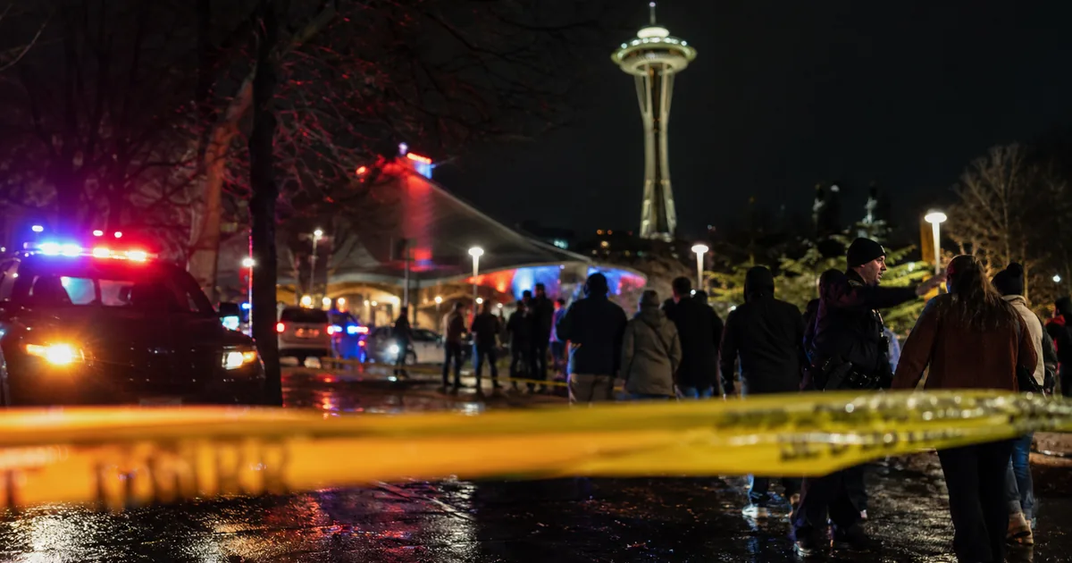 Police emergency lights and yellow tape at Seattle Center near the Space Needle after a mass shooting at the Bite of Seattle festival