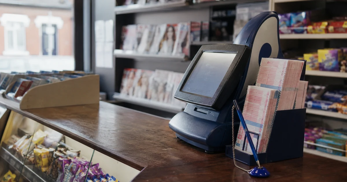 Lottery terminal and play slips on the counter of a British corner shop