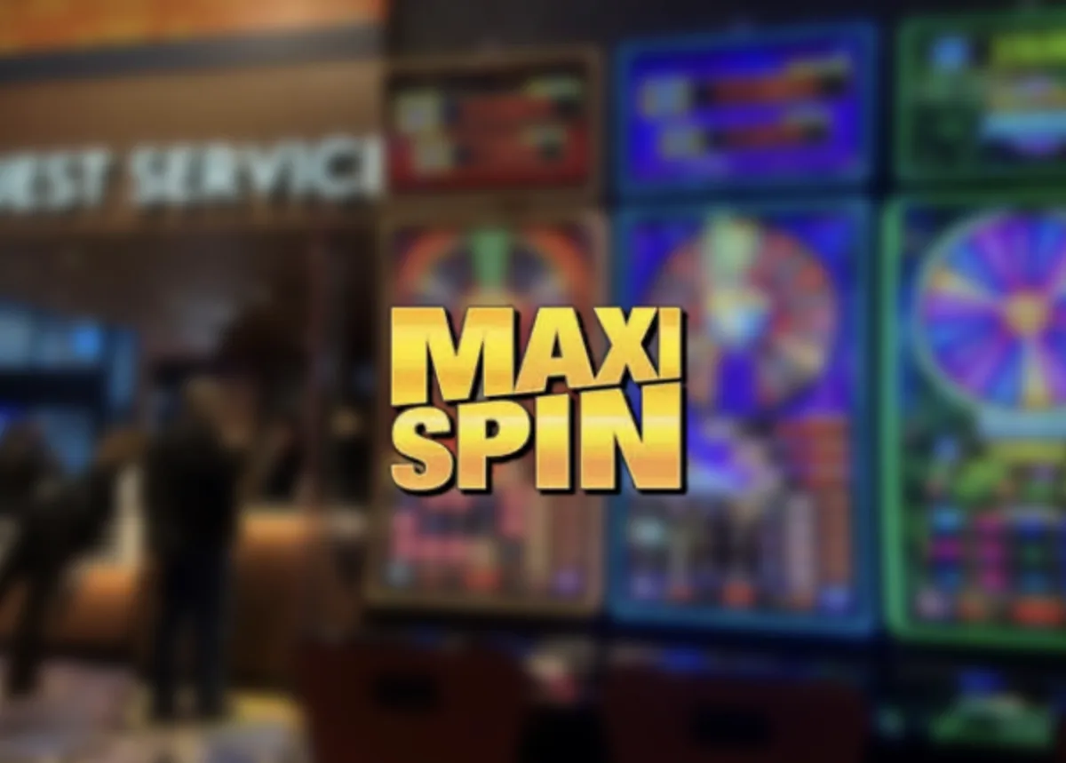 Maxispin Casino branding over a blurred casino gaming floor