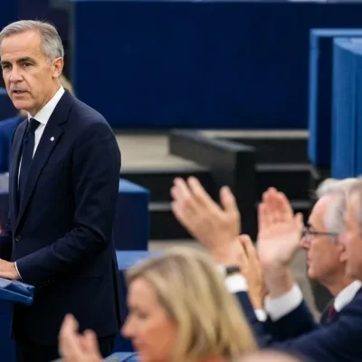 Canadian Prime Minister Mark Carney speaks at the European Parliament podium in Strasbourg as MEPs applaud