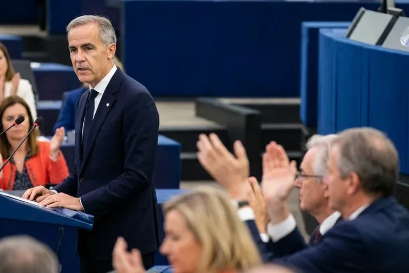 Canadian Prime Minister Mark Carney speaks at the European Parliament podium in Strasbourg as MEPs applaud