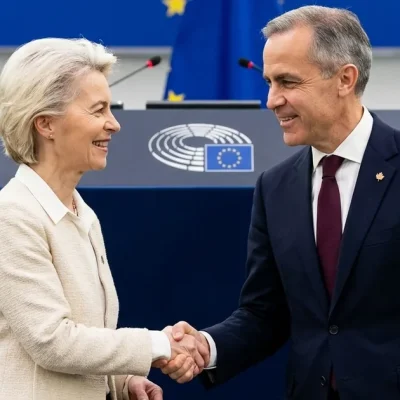 European Commission President Ursula von der Leyen shakes hands with Canadian Prime Minister Mark Carney in front of the European Parliament rostrum in Strasbourg as lawmakers applaud