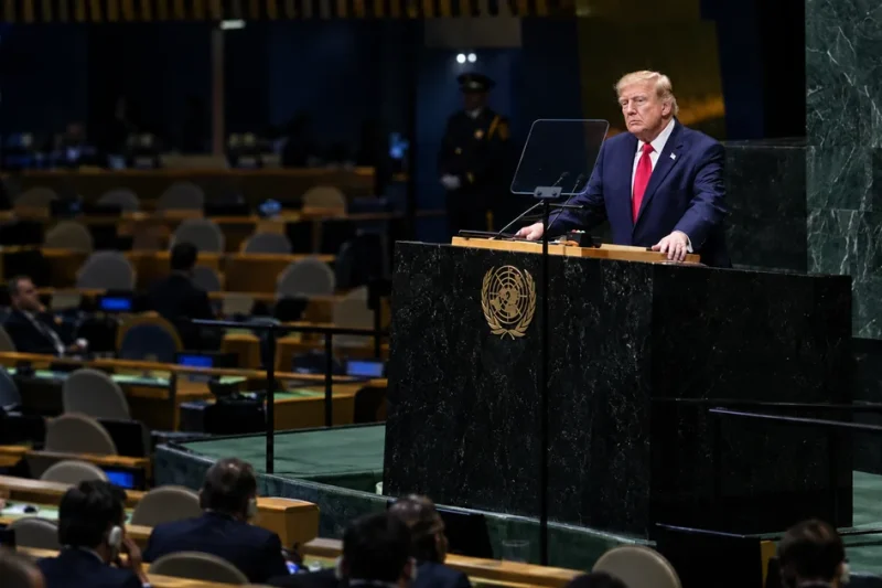 Donald Trump grips the green marble UN General Assembly rostrum while delegates sit in a half-empty hall