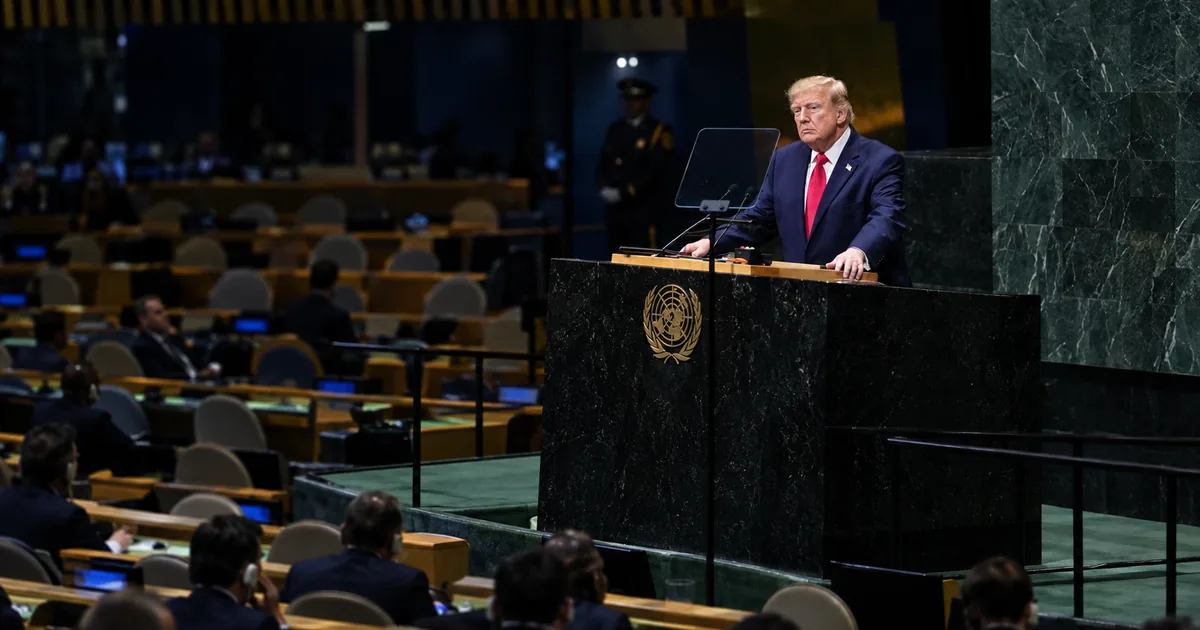Donald Trump grips the green marble UN General Assembly rostrum while delegates sit in a half-empty hall