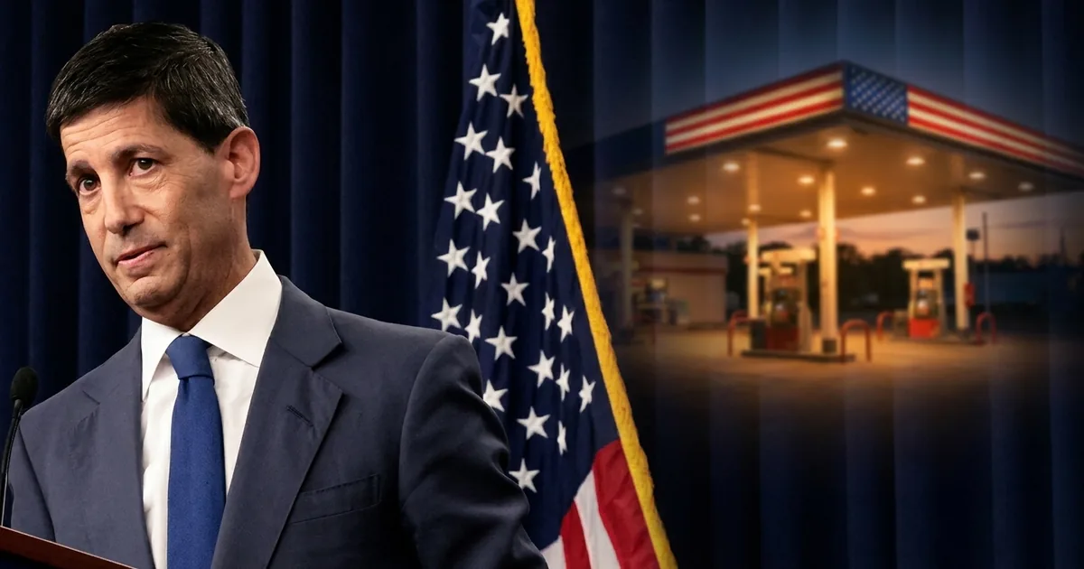 Federal Reserve Chair Kevin Warsh at a lectern in front of a navy curtain and American flag, with a lit gas station at dusk blended into the background