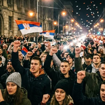 Illustrative image: a crowd of young people with raised fists and Serbian flags celebrating in a Belgrade street at night