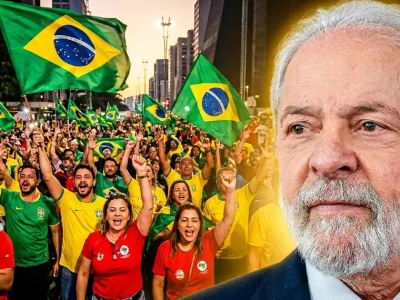 Brazilian President Luiz Inacio Lula da Silva in the foreground as a crowd of supporters in green, yellow and red wave Brazilian flags at a street rally.